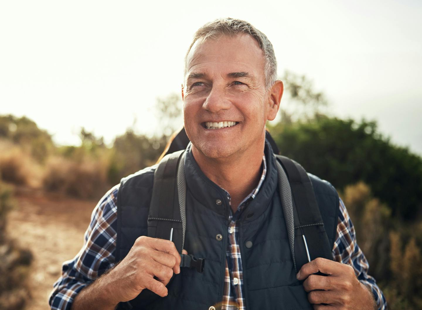 man on a hike smiling