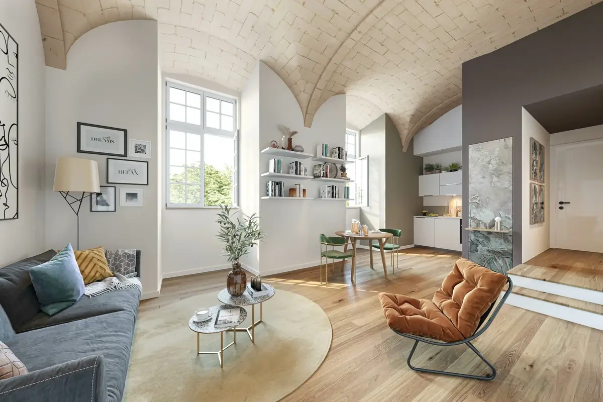 Intérieur d'un appartement de prestige entièrement rénové sous le dispositif de la loi Malraux, avec plafond voûté en pierre apparente et parquet, illustrant un investissement locatif d'exception.