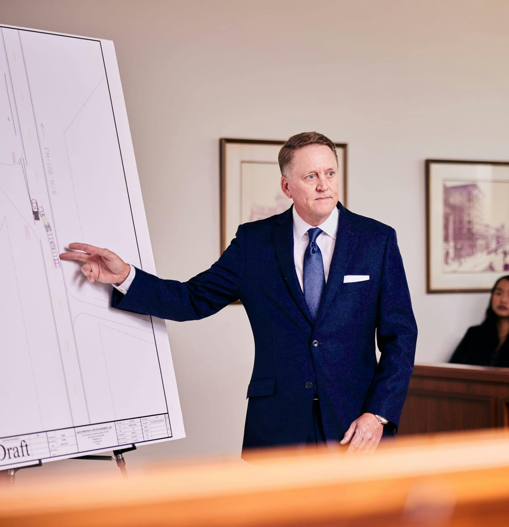 Perdue pointing to a diagram of a car wreck