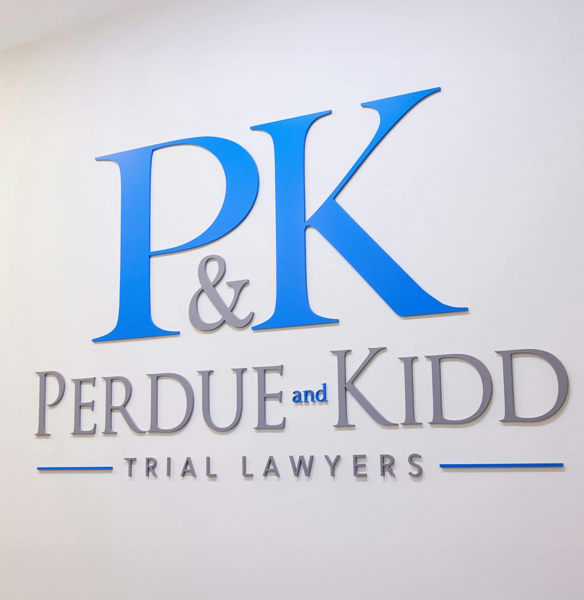 sign for a law firm with a blue and white logo