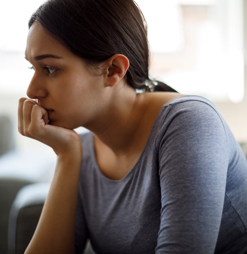 Concerned woman in her home