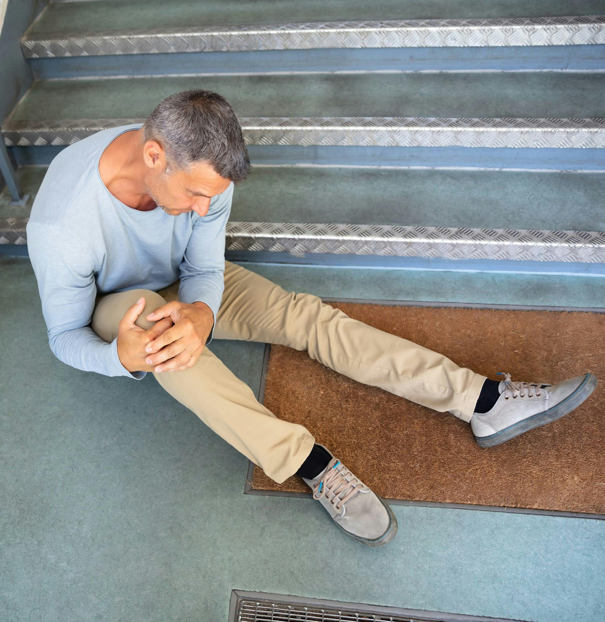 Man on the floor holding his knee