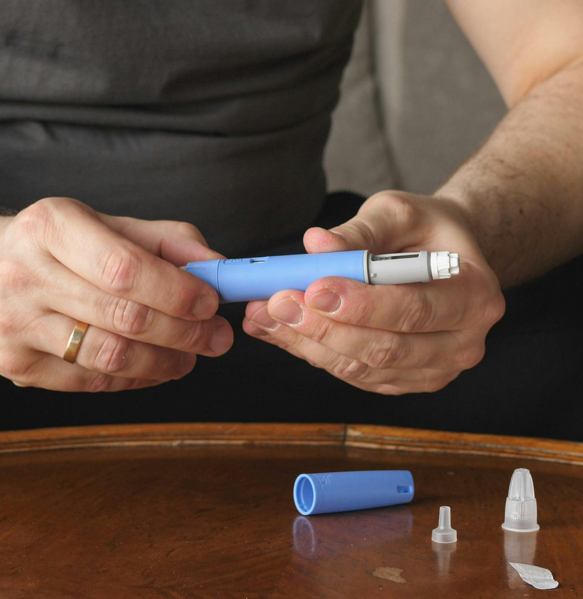 Person looking at prescription injection