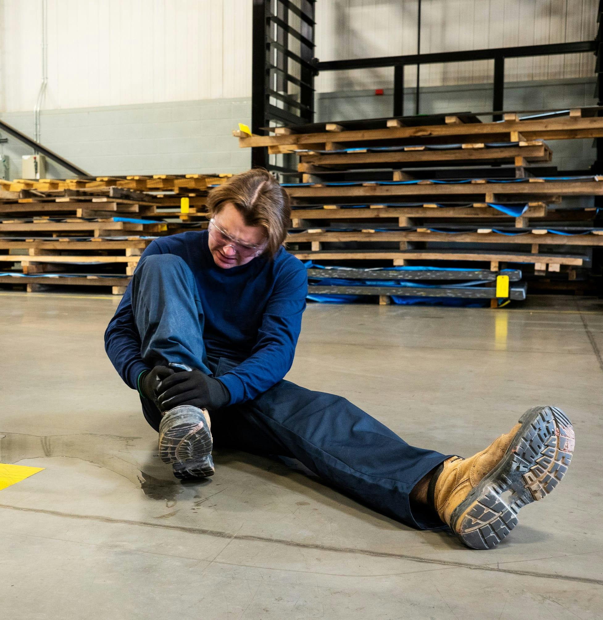 Warehouse worker holding their ankle