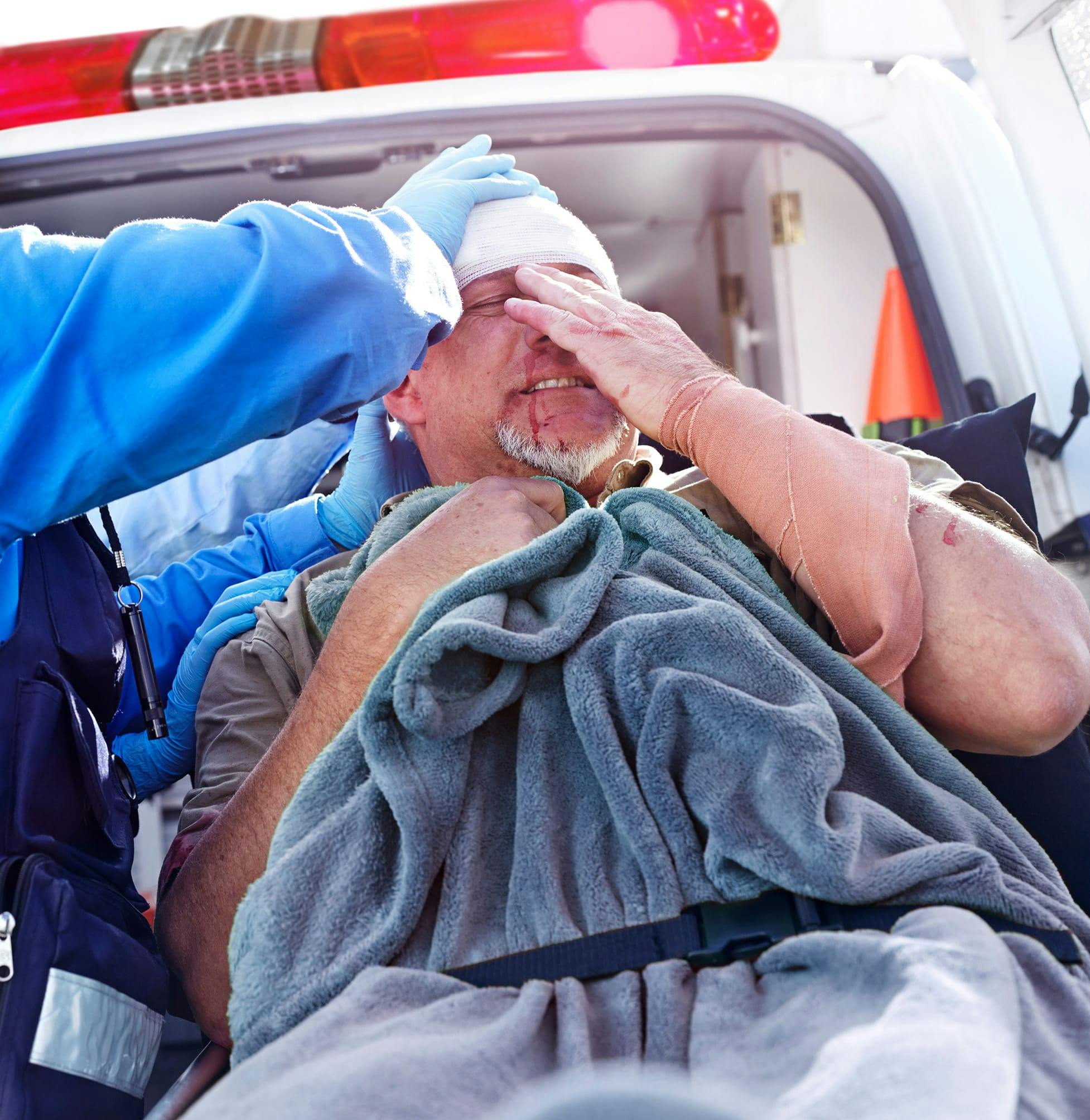 Man injured holding his head