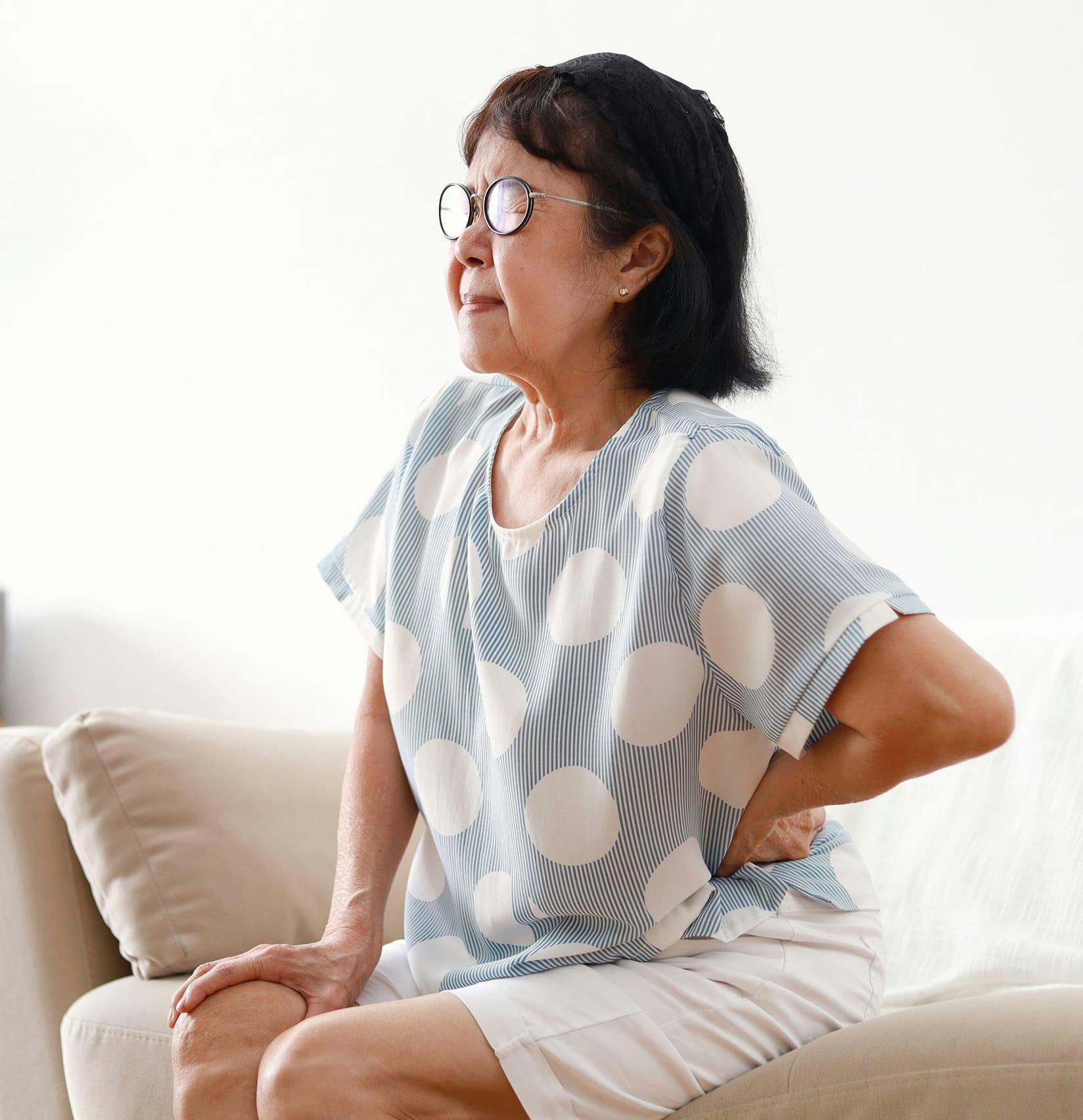 Elderly woman holding her hip