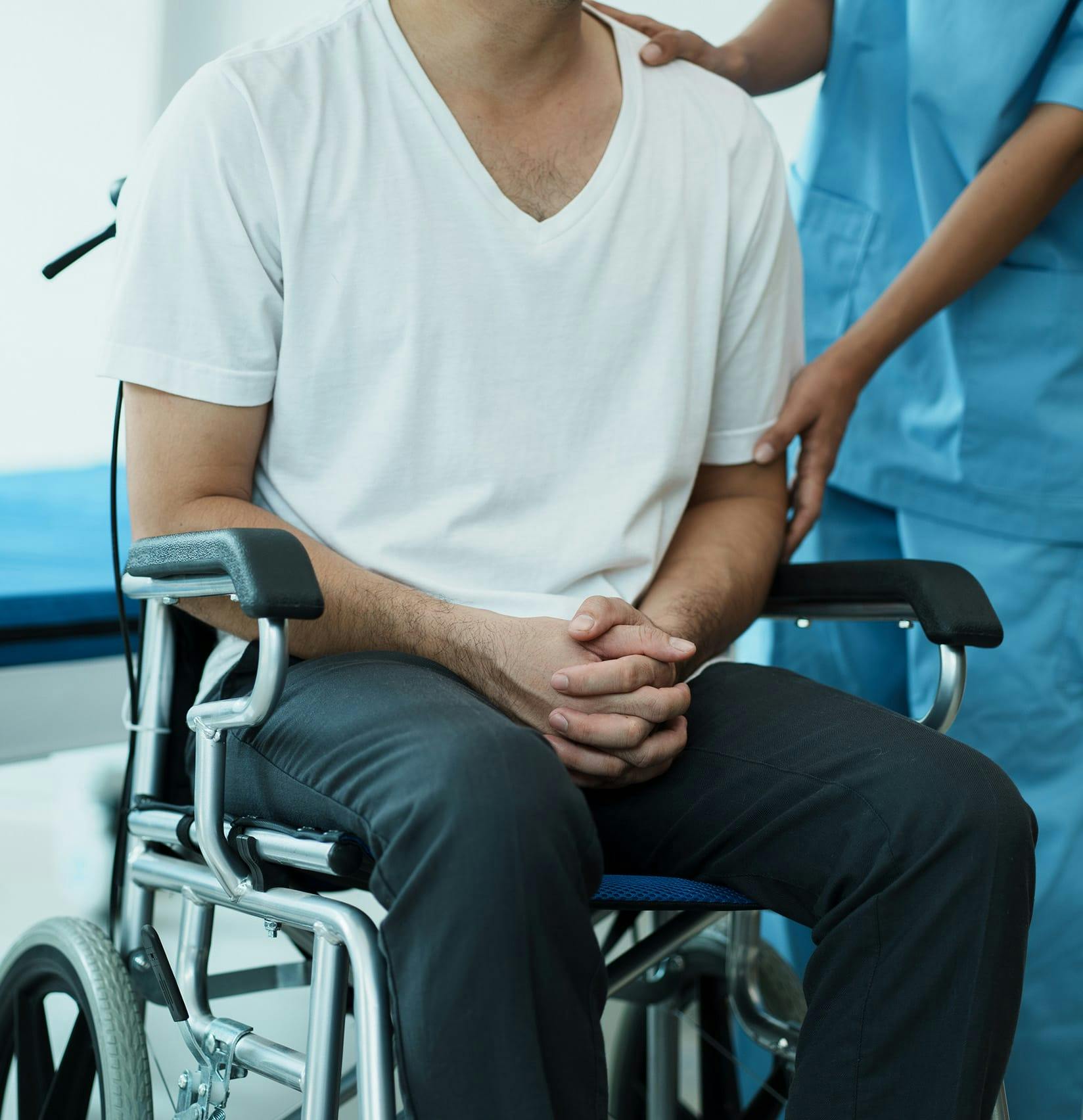 Person in a wheelchair next to a nurse
