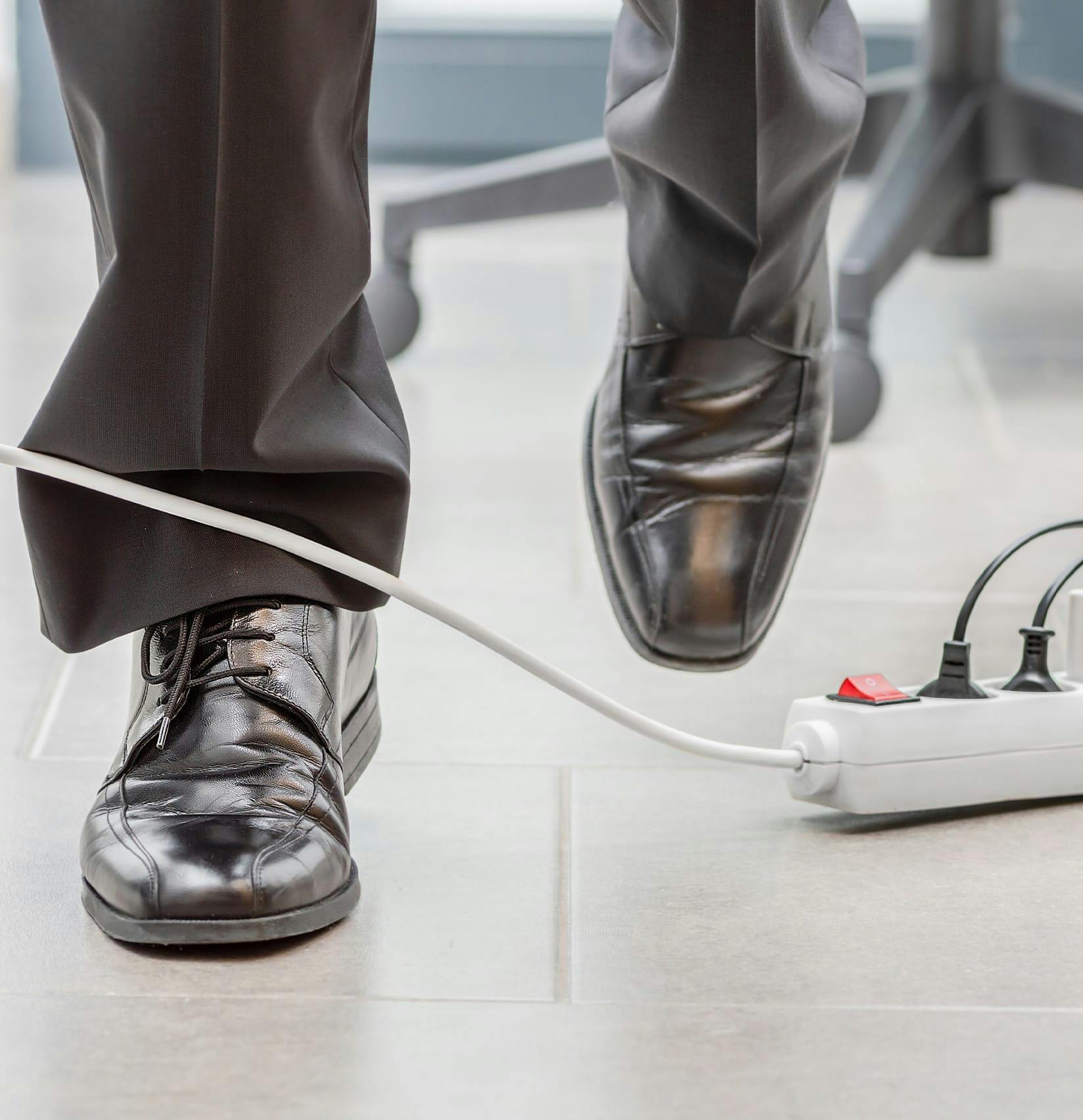 Person walking about to trip on a surge protector
