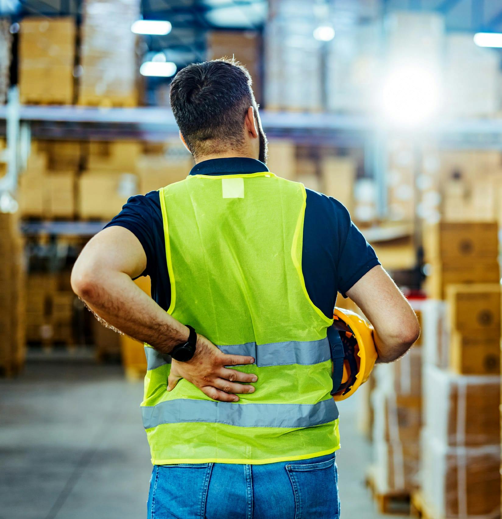 Warehouse worker holding his back