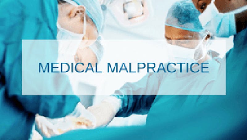 Medical malpractice words with an  operating room in the background