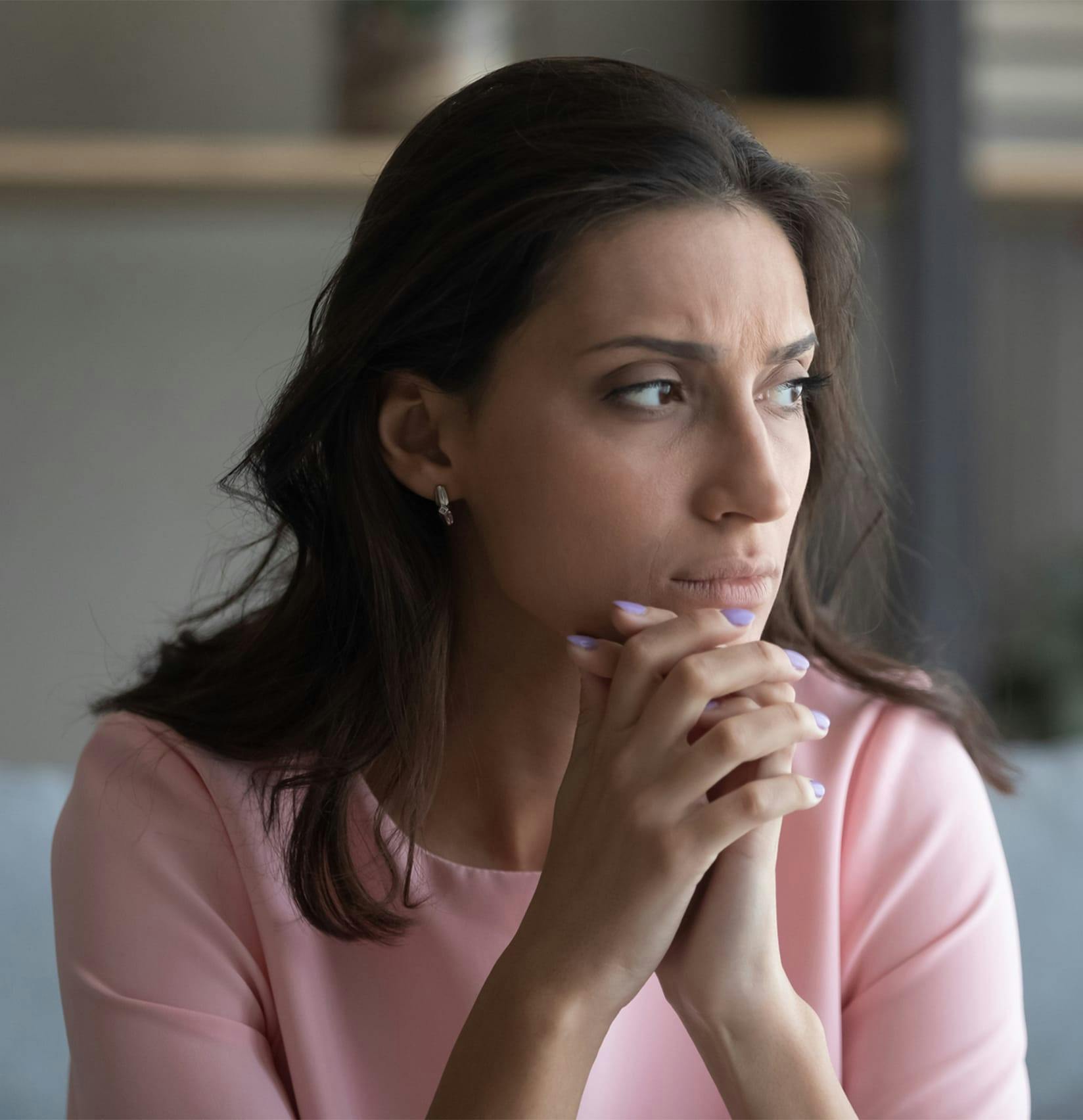Concerned woman looking out the window