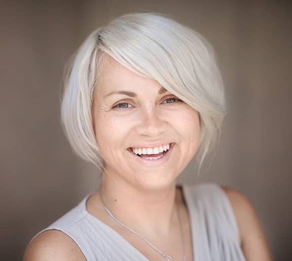 Middle-aged woman happy smiling. Dr. Buckingham has years of training and experience in performing rhinoplasty for middle-aged patients.