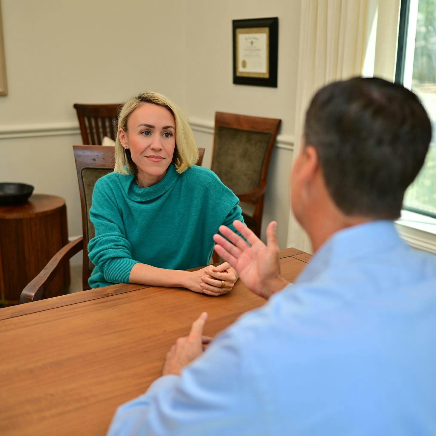 man and woman having a conversation at a table