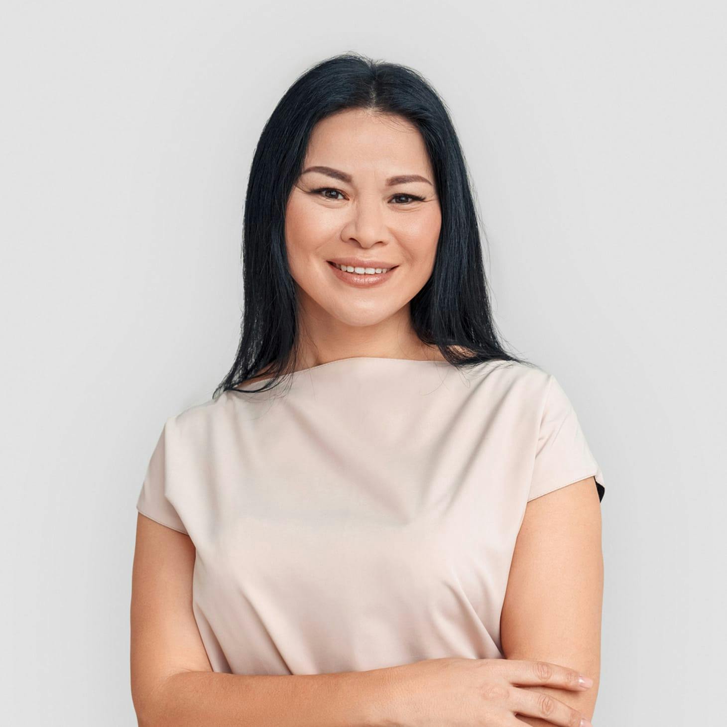 older woman smiling crossing her arms