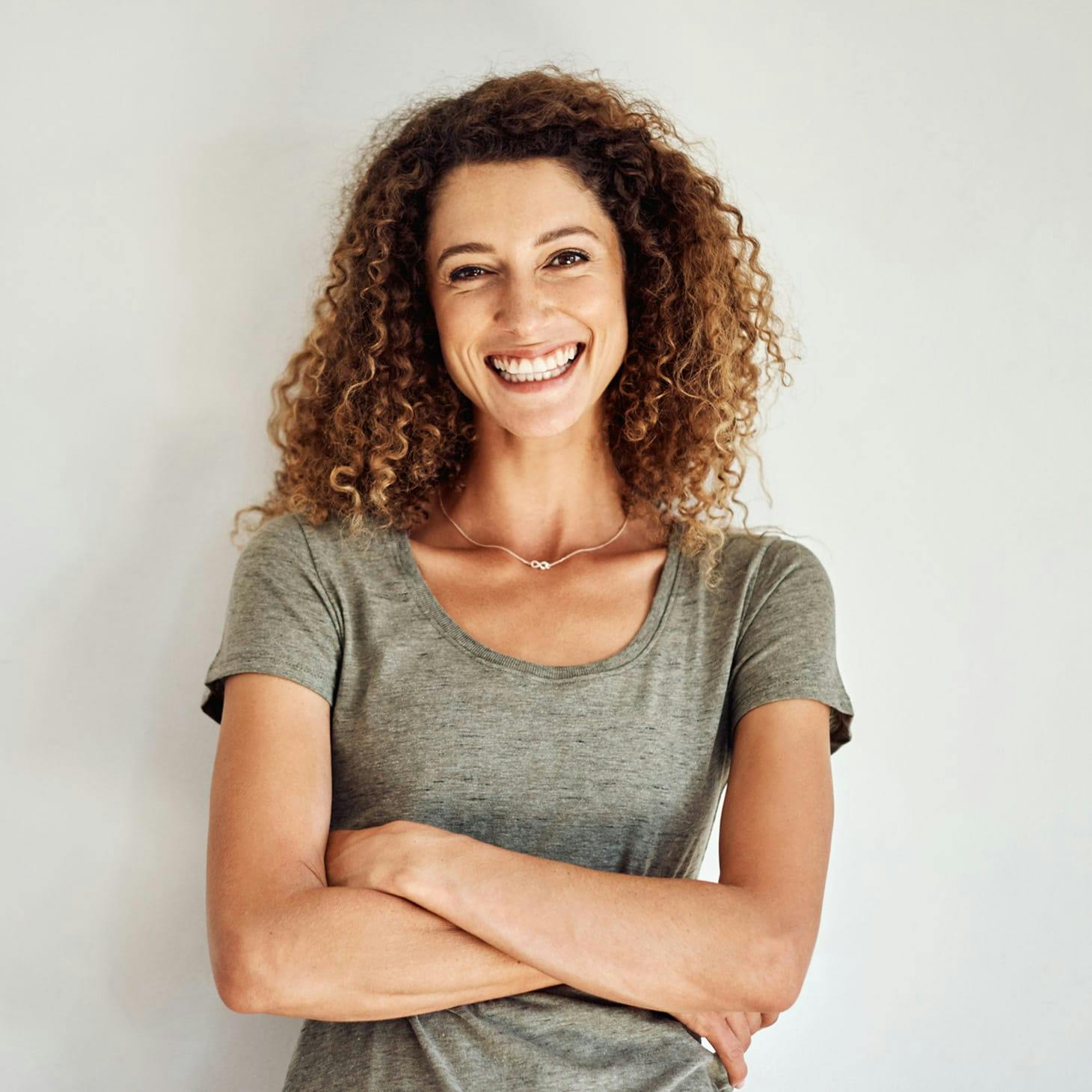 smiling woman with her arms crossed