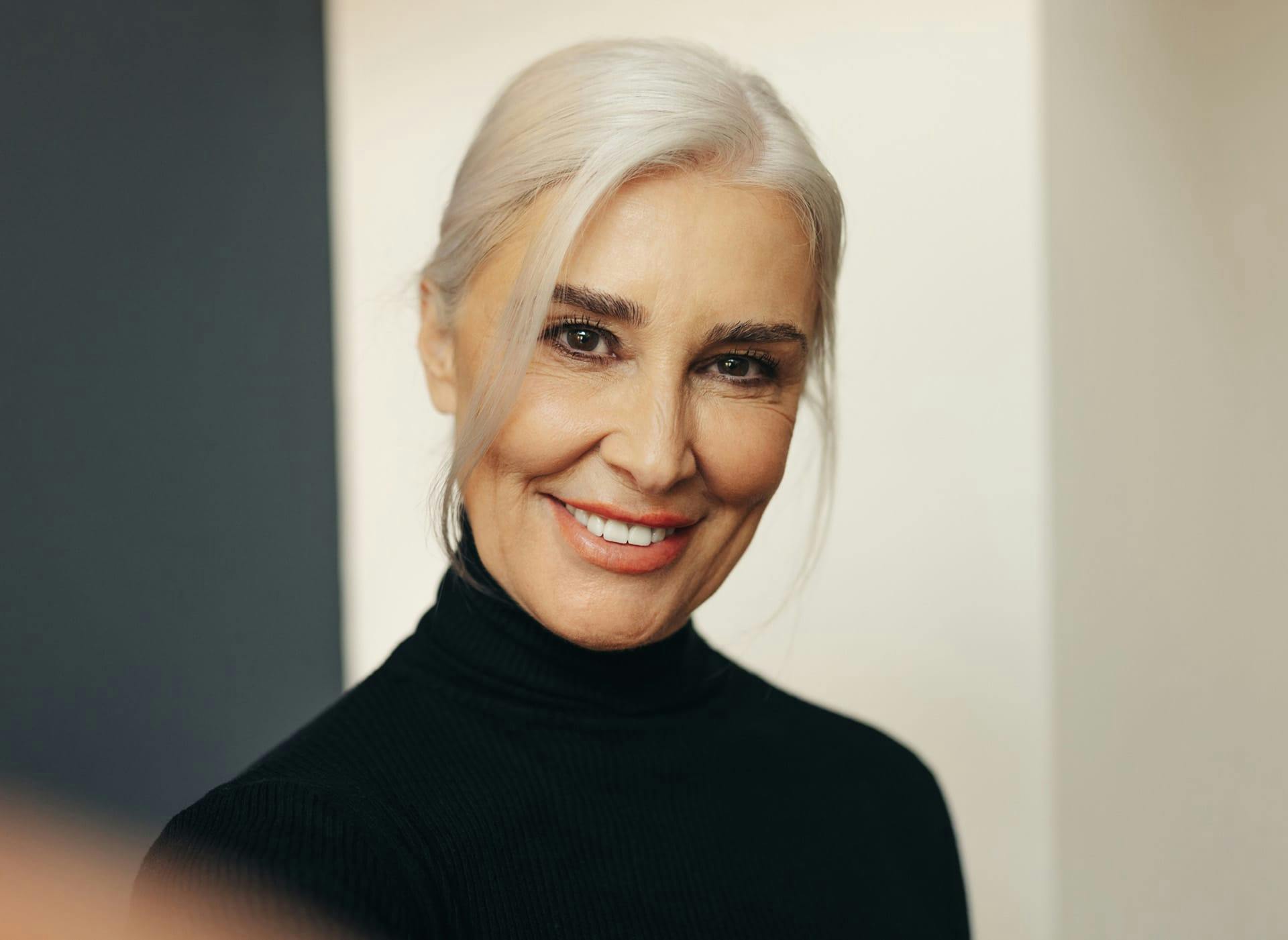 woman with white hair wearing a black top