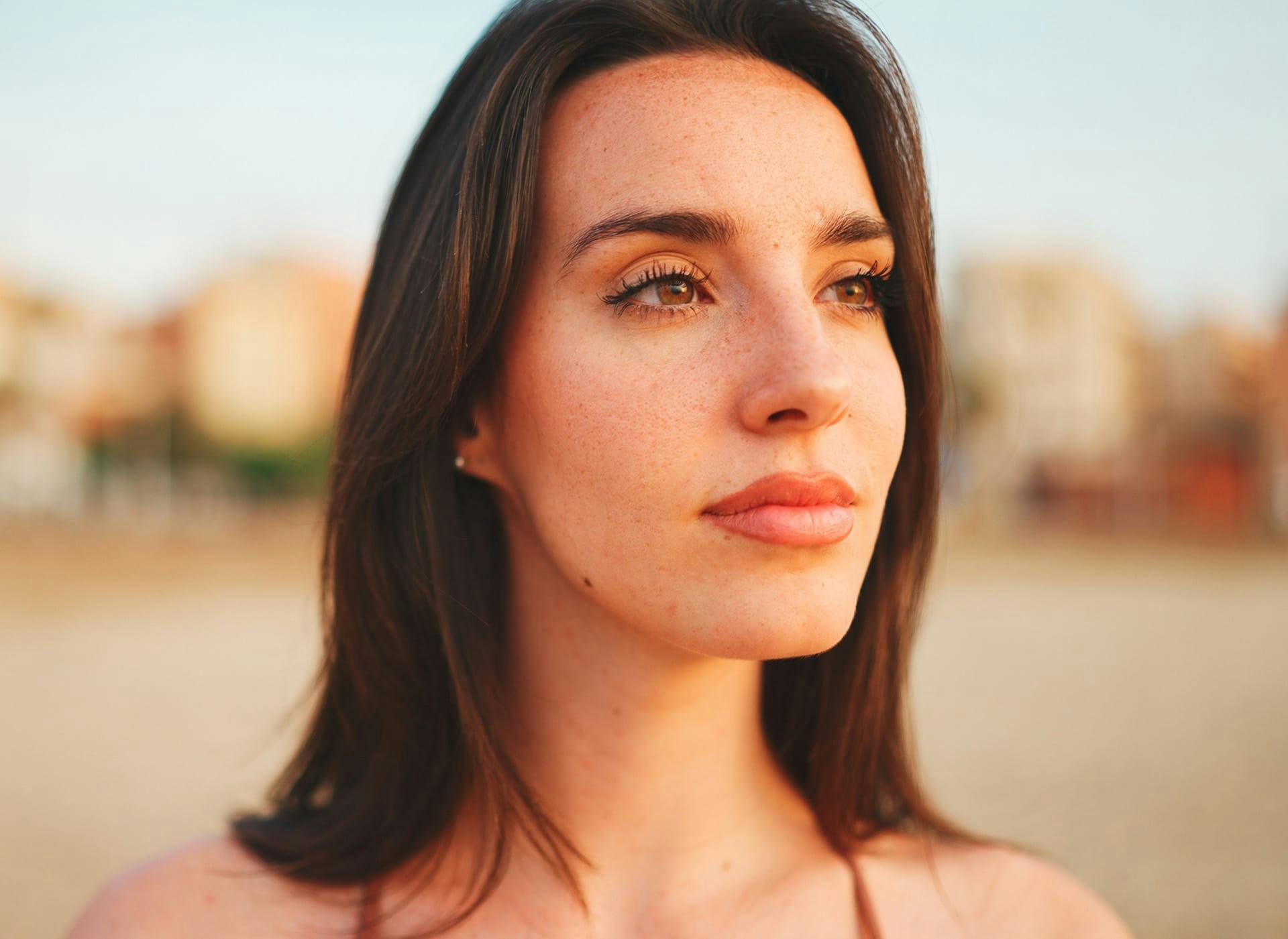 woman with brown hair and freckles