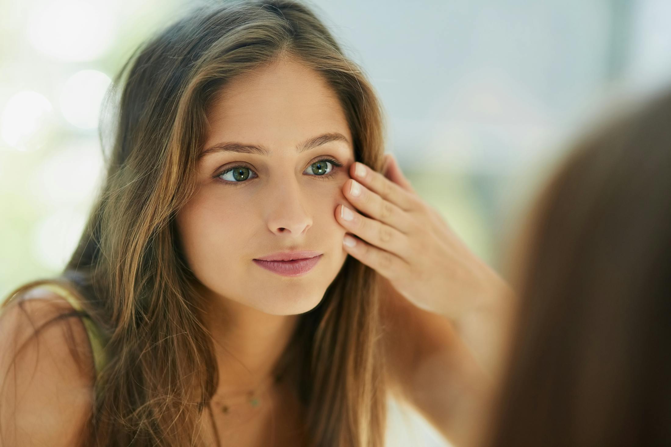 Woman touching her face