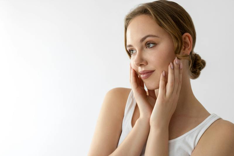 Woman touching her face