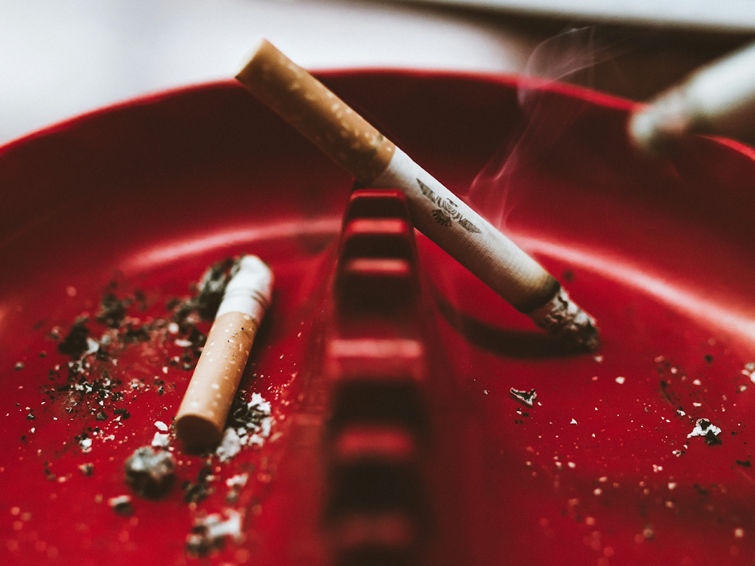 Photo by <a href="https://unsplash.com/@sadswim?utm_content=creditCopyText&utm_medium=referral&utm_source=unsplash">ian dooley</a> on <a href="https://unsplash.com/photos/shallow-focus-photo-of-white-cigarette-stick-on-red-ashtray-XlP4kZnr2i8?utm_content=creditCopyText&utm_medium=referral&utm_source=unsplash">Unsplash</a>