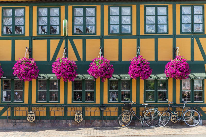Gammel flot gul bygning, med smukke blomster