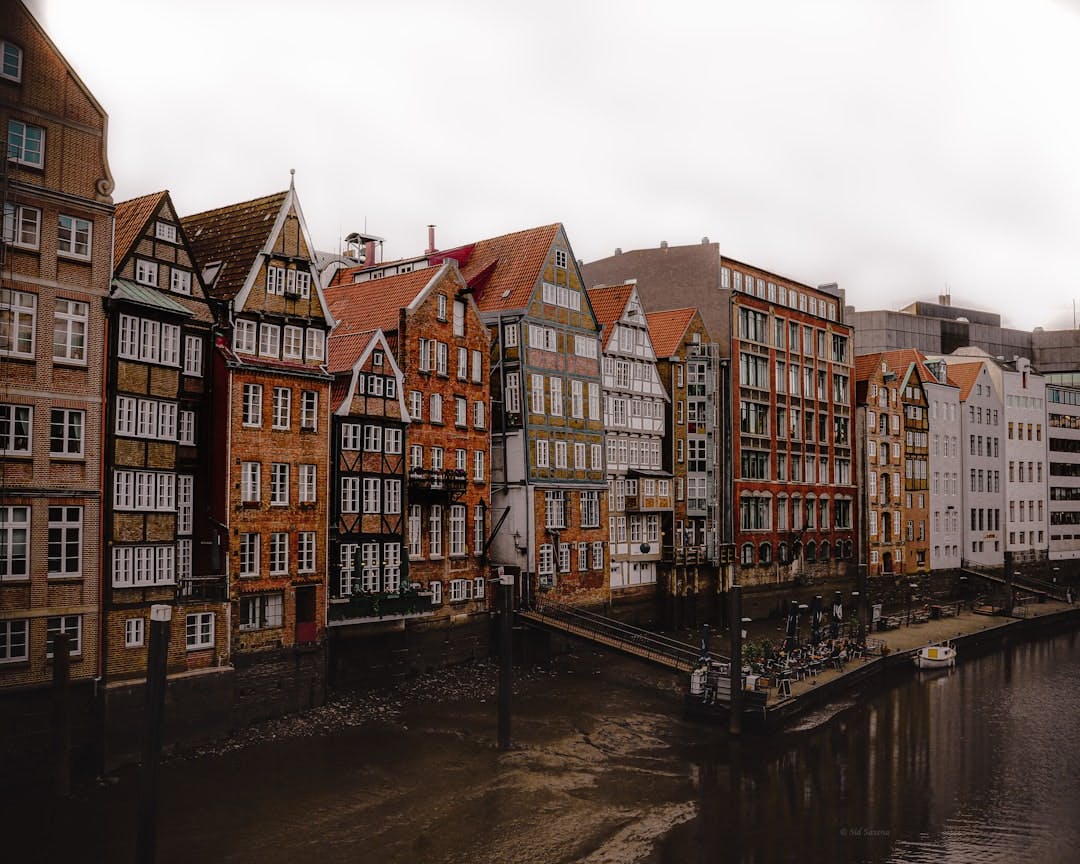 Historic gabled buildings along a canal in a German old town.