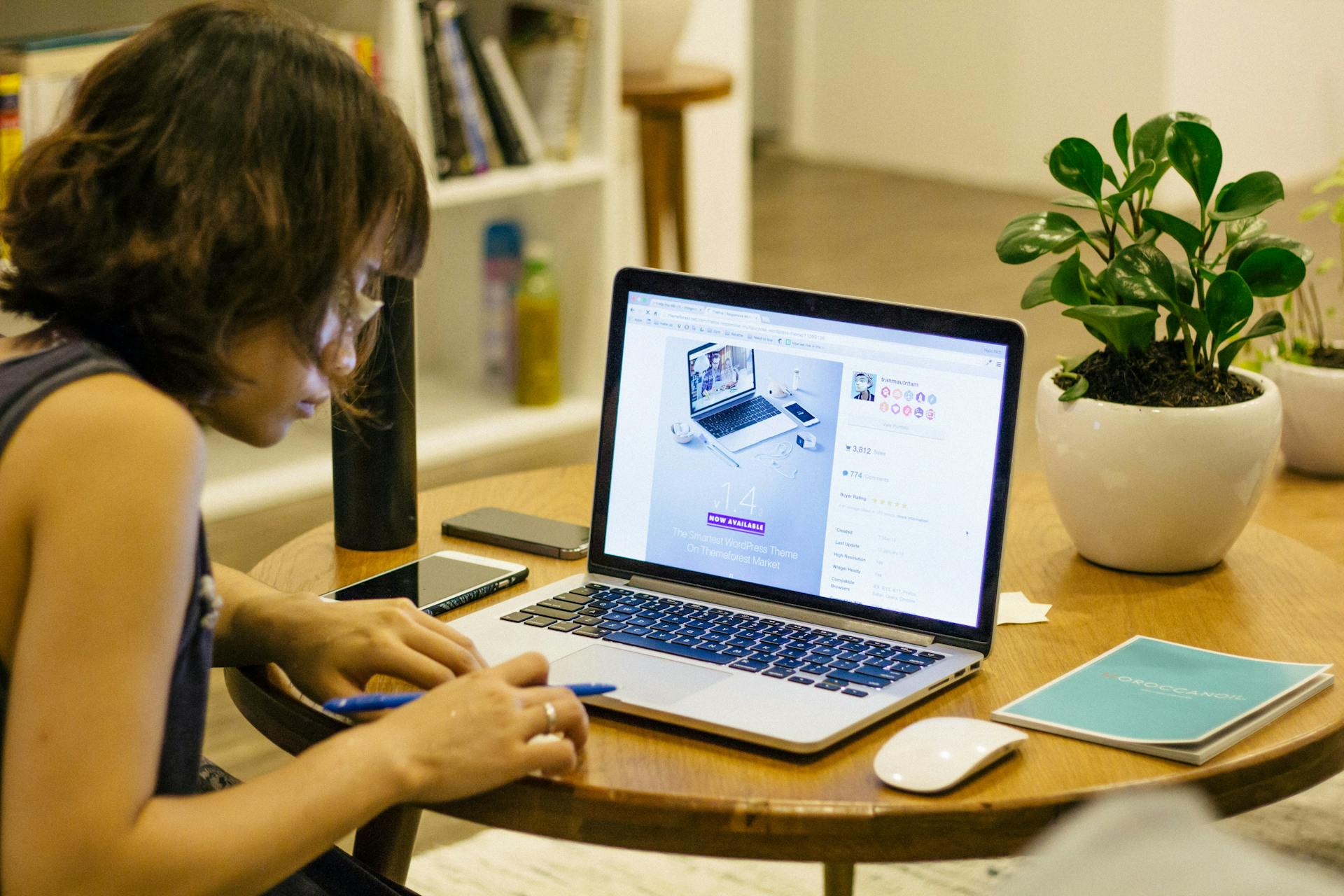Young woman checking her credit score on a laptop (Photo by Tran Mau Tri Tam ✪ on Unsplash)
