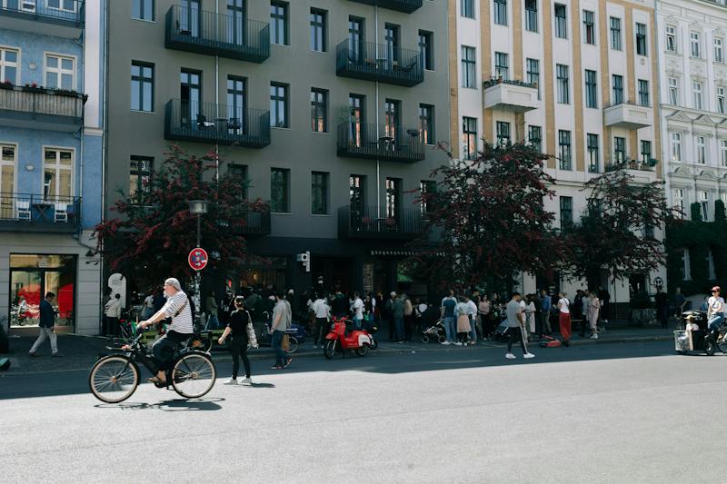 Cyclist on a Berlin street between residential buildings (Photo by Nataliya Shemetova on Unsplash)