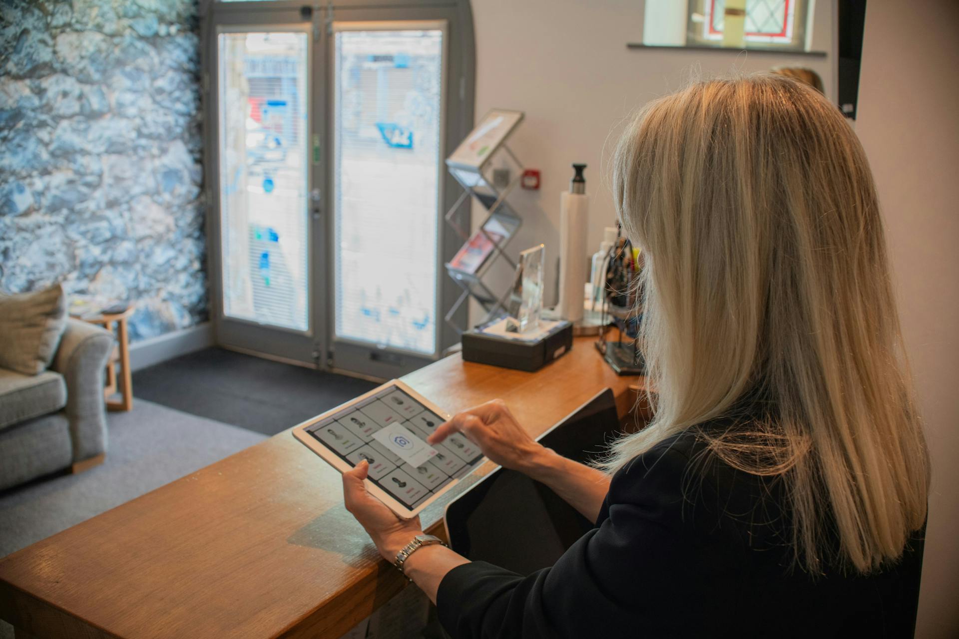 Young woman at an office counter with paperwork (Photo by Bluestonex on Unsplash)