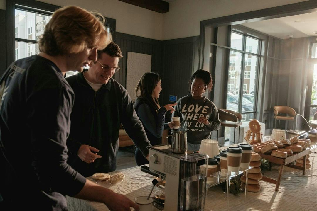 Students reading together at a table in an apartment (Photo by Apartment Life on Unsplash)