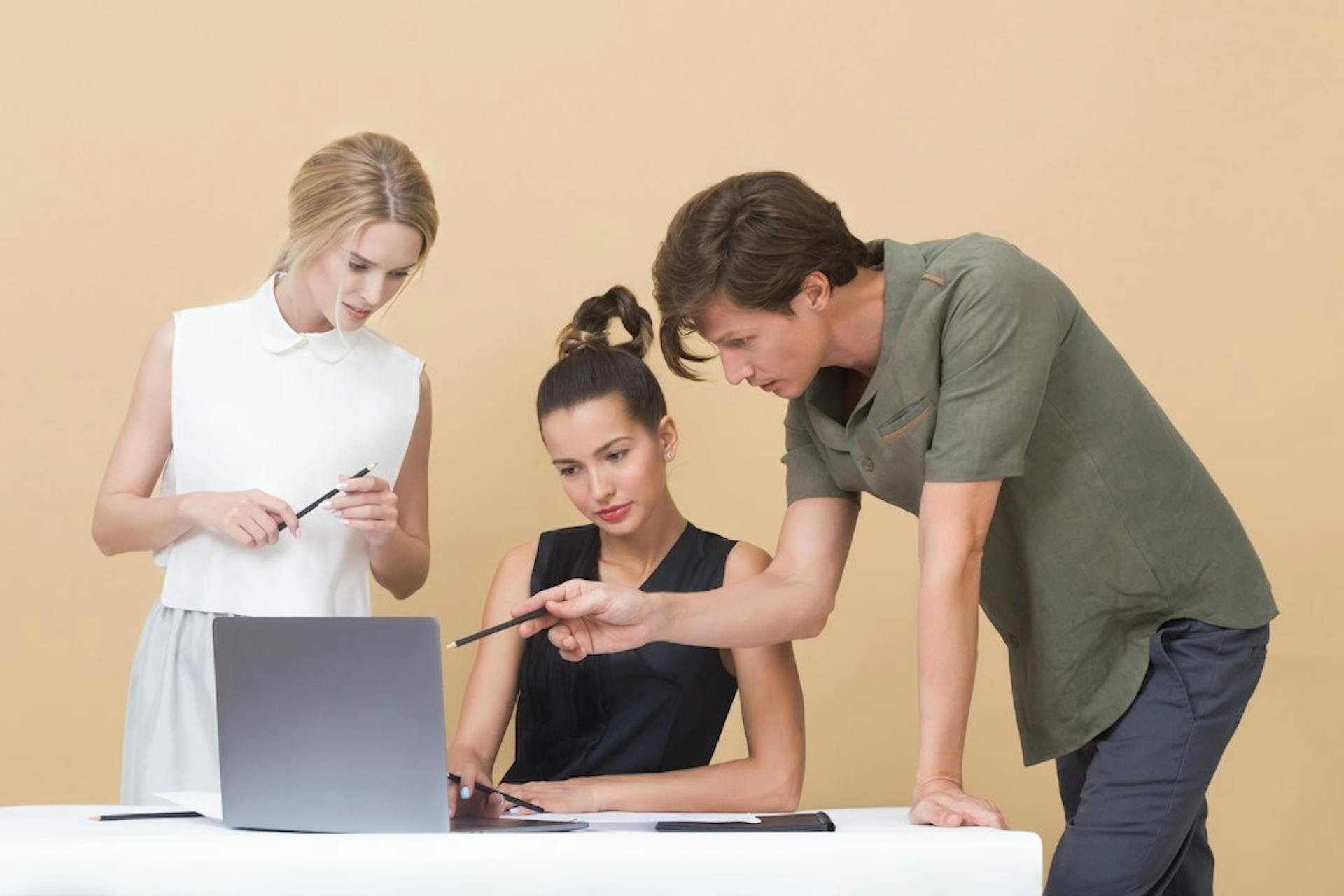 Young people putting together a rental application with documents and a laptop (Photo by Icons8 Team on Unsplash)