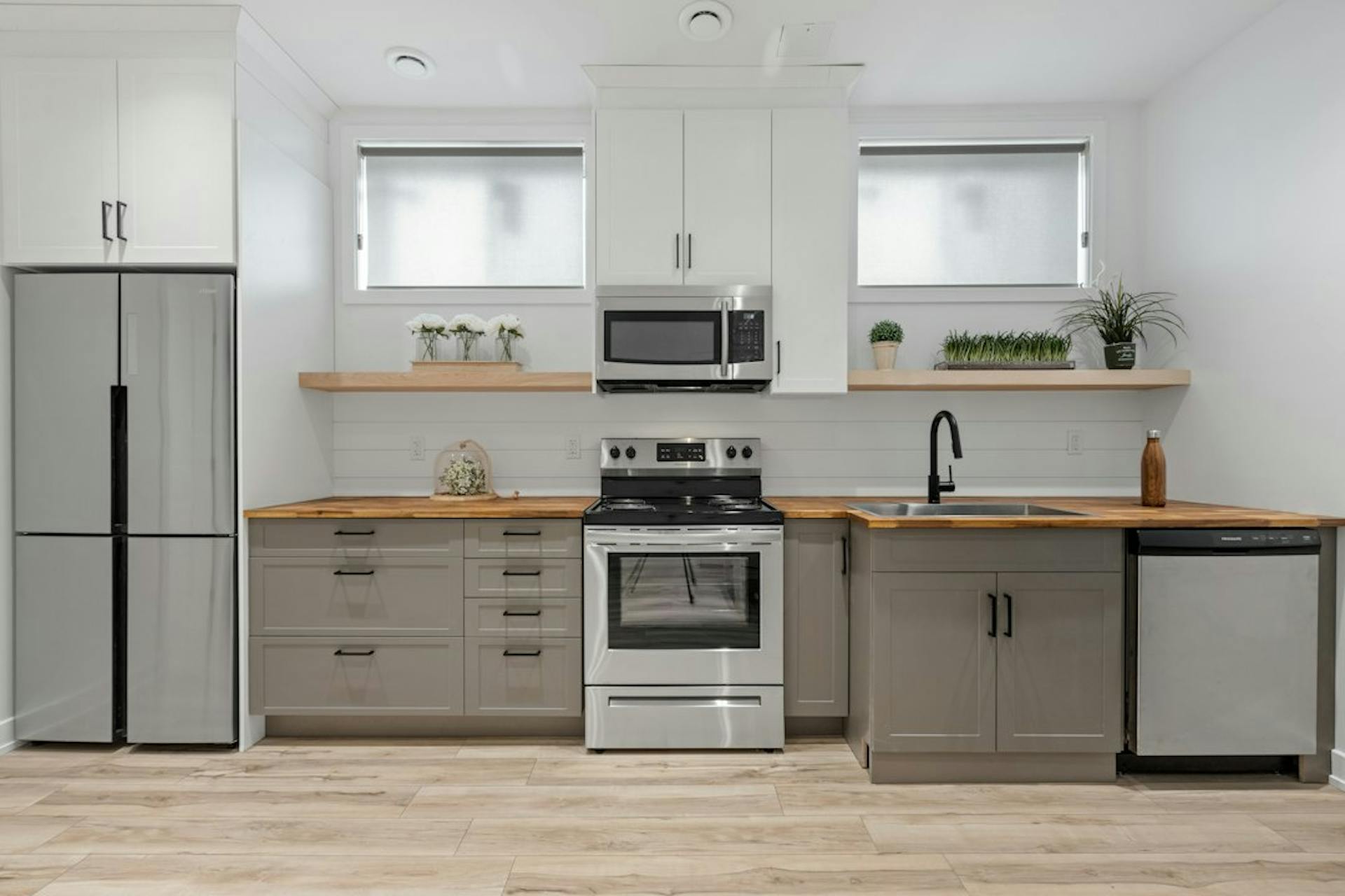 Bright newly renovated kitchen with white cabinets (Photo by Point3D Commercial Imaging Ltd. on Unsplash)
