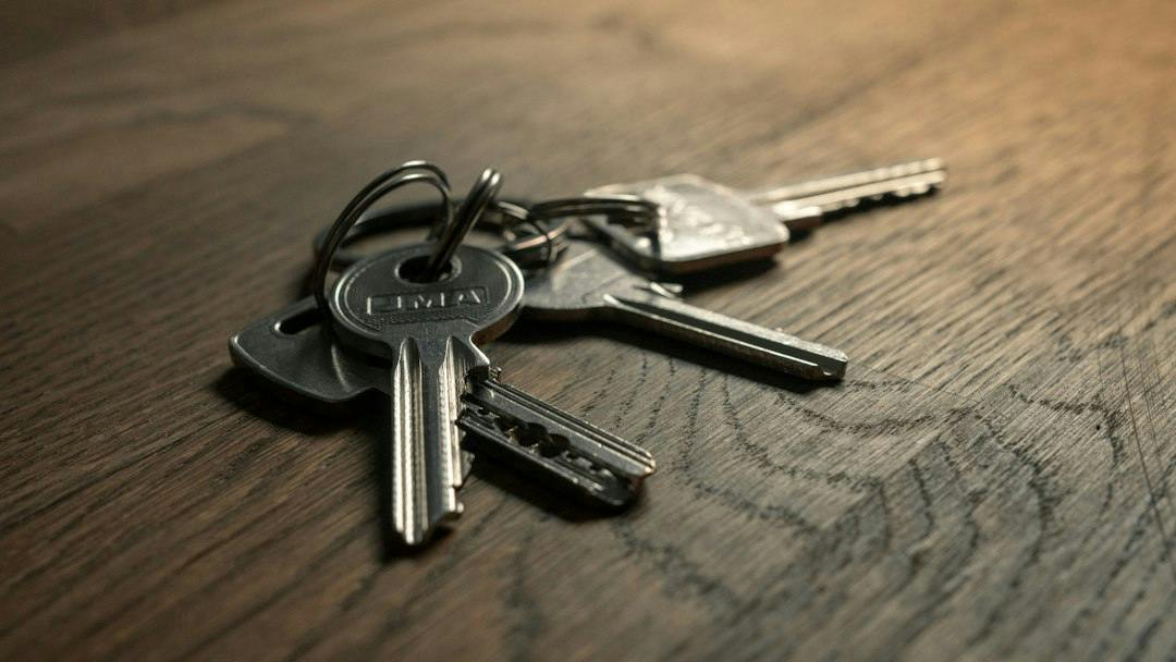 Set of keys lying on a wooden table (Photo by Filip Szalbot on Unsplash)