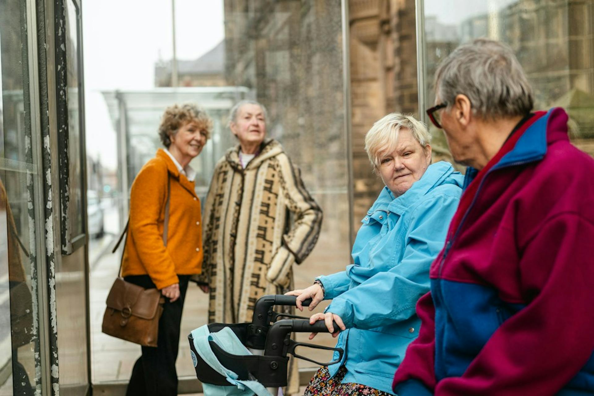 Group of older friends talking on a city street (Photo by Centre for Ageing Better on Unsplash)