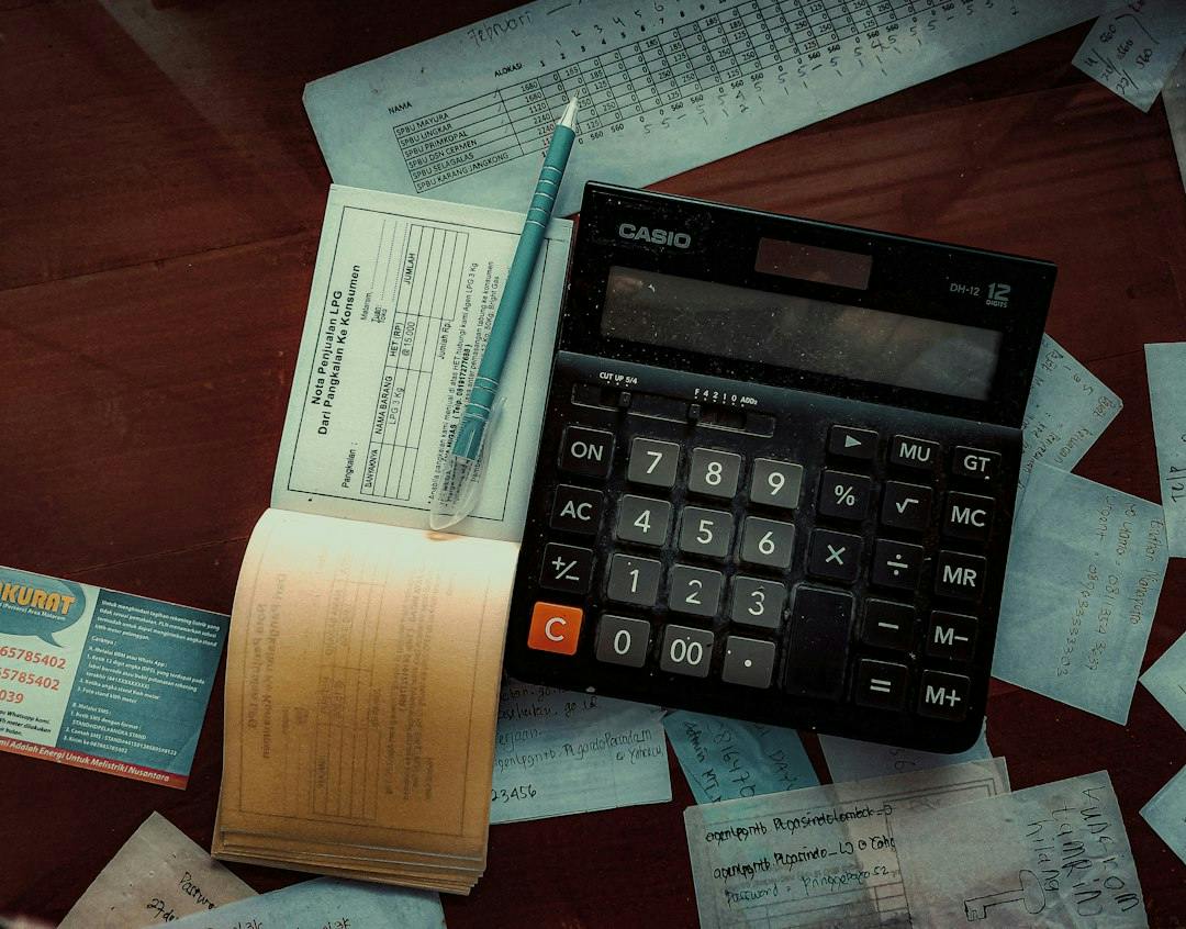 Calculator and receipts spread on a table (Photo by FIN on Unsplash)