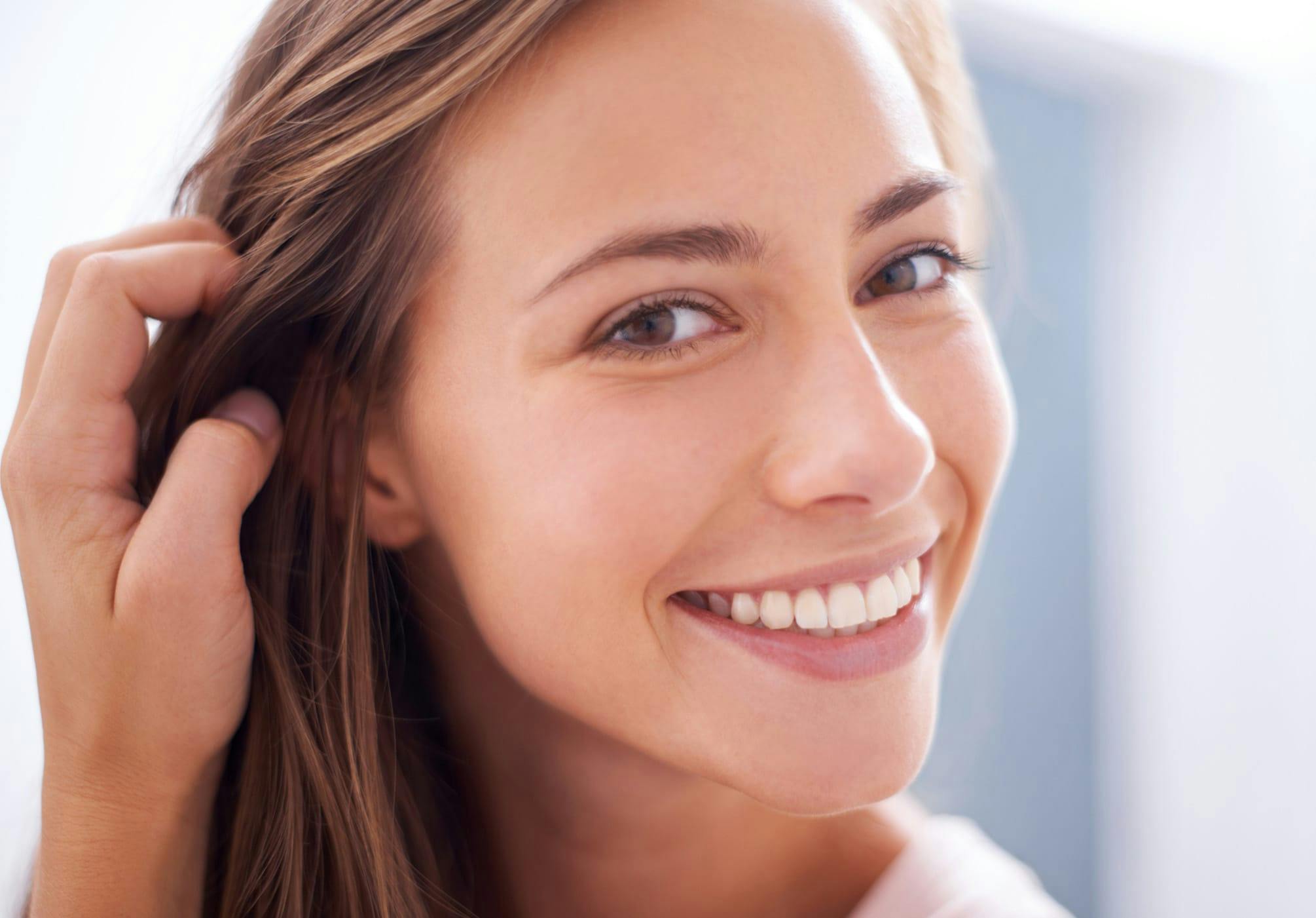 Woman tucking her hair behind her ear