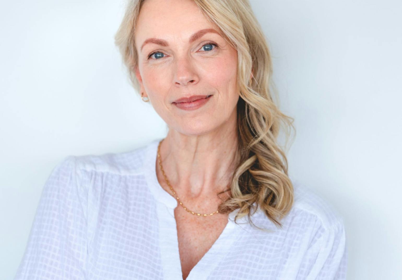 woman with blonde hair in a white top