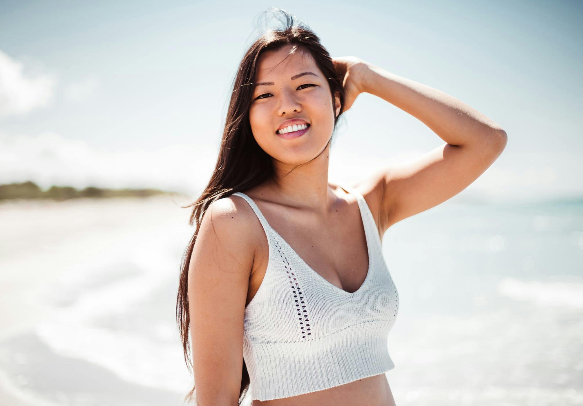 woman in a white top at the beach