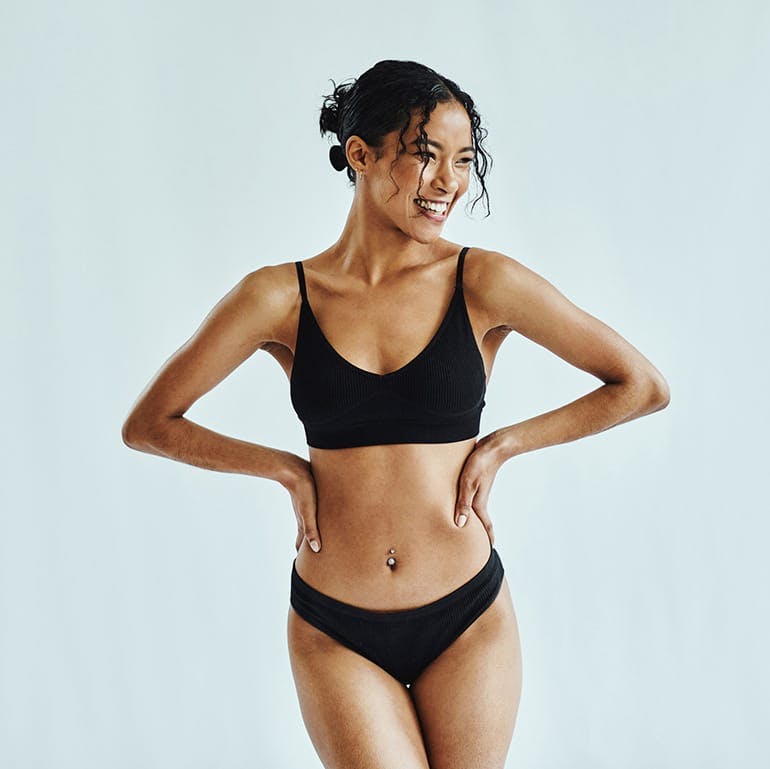 woman in undergarments smiling