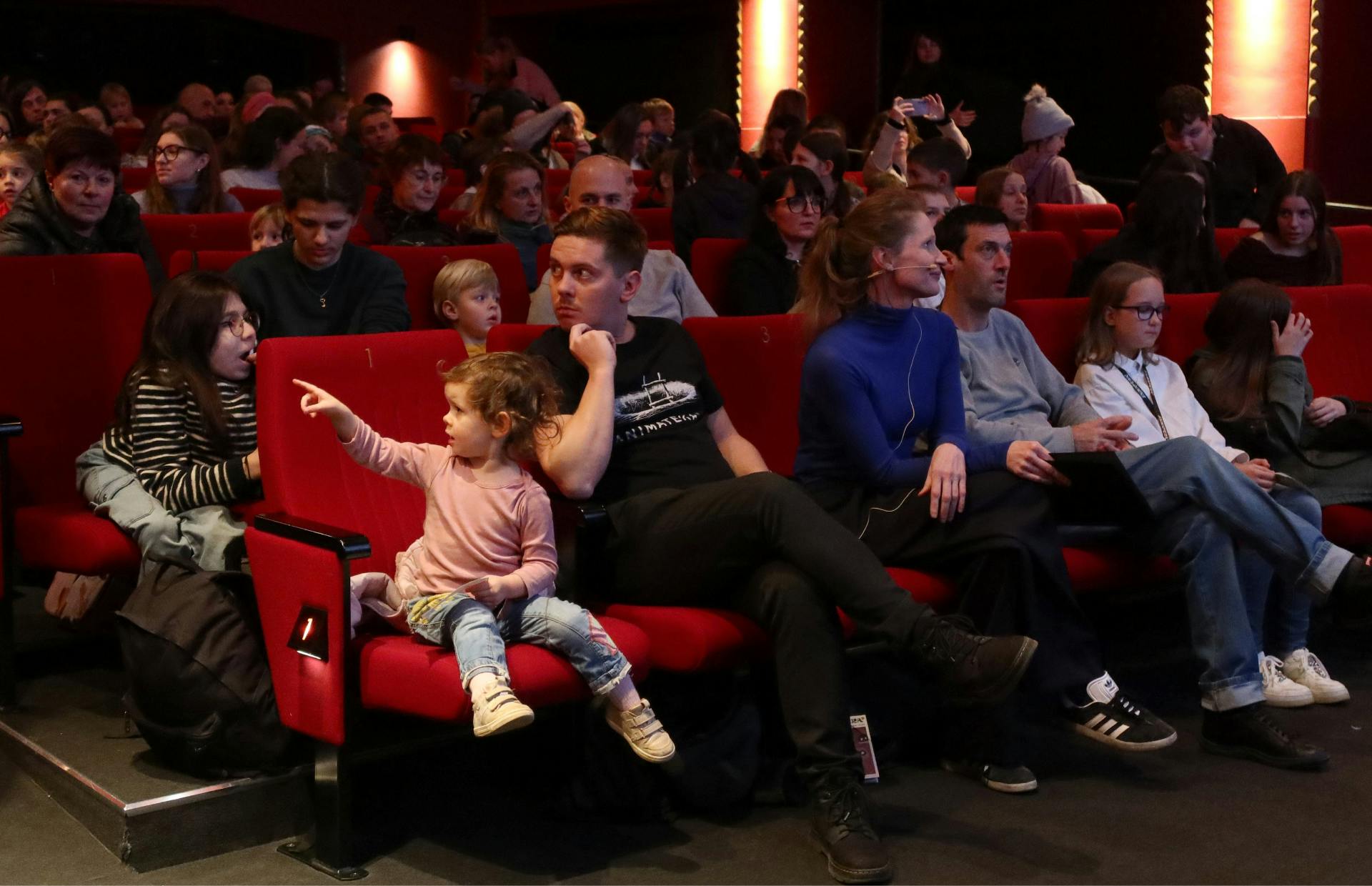 Prve vrste dvorane Kinodvora, zapolnjene z otroci s starši