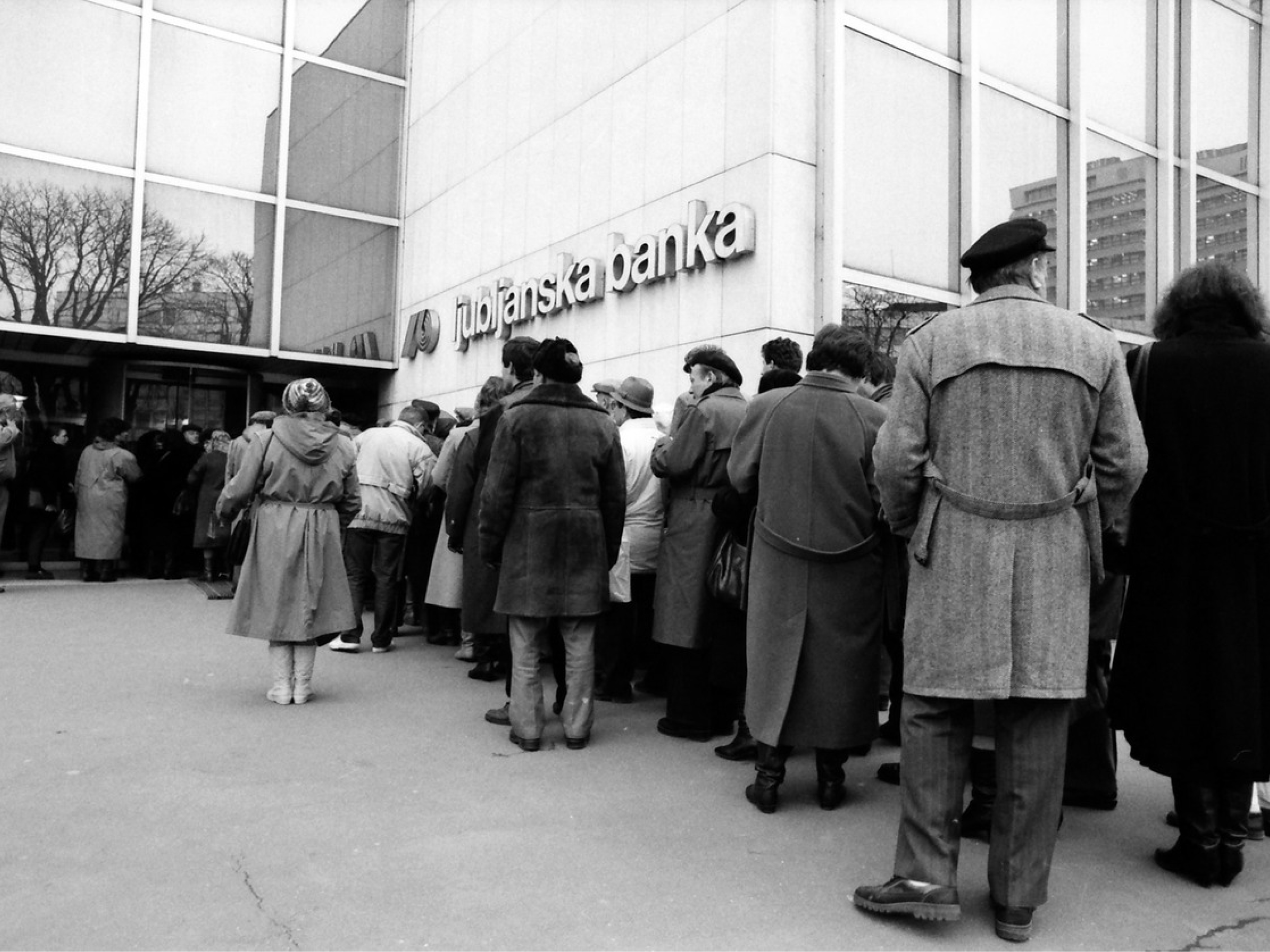Črno-bela fotografija vrste pred Ljubljansko banko