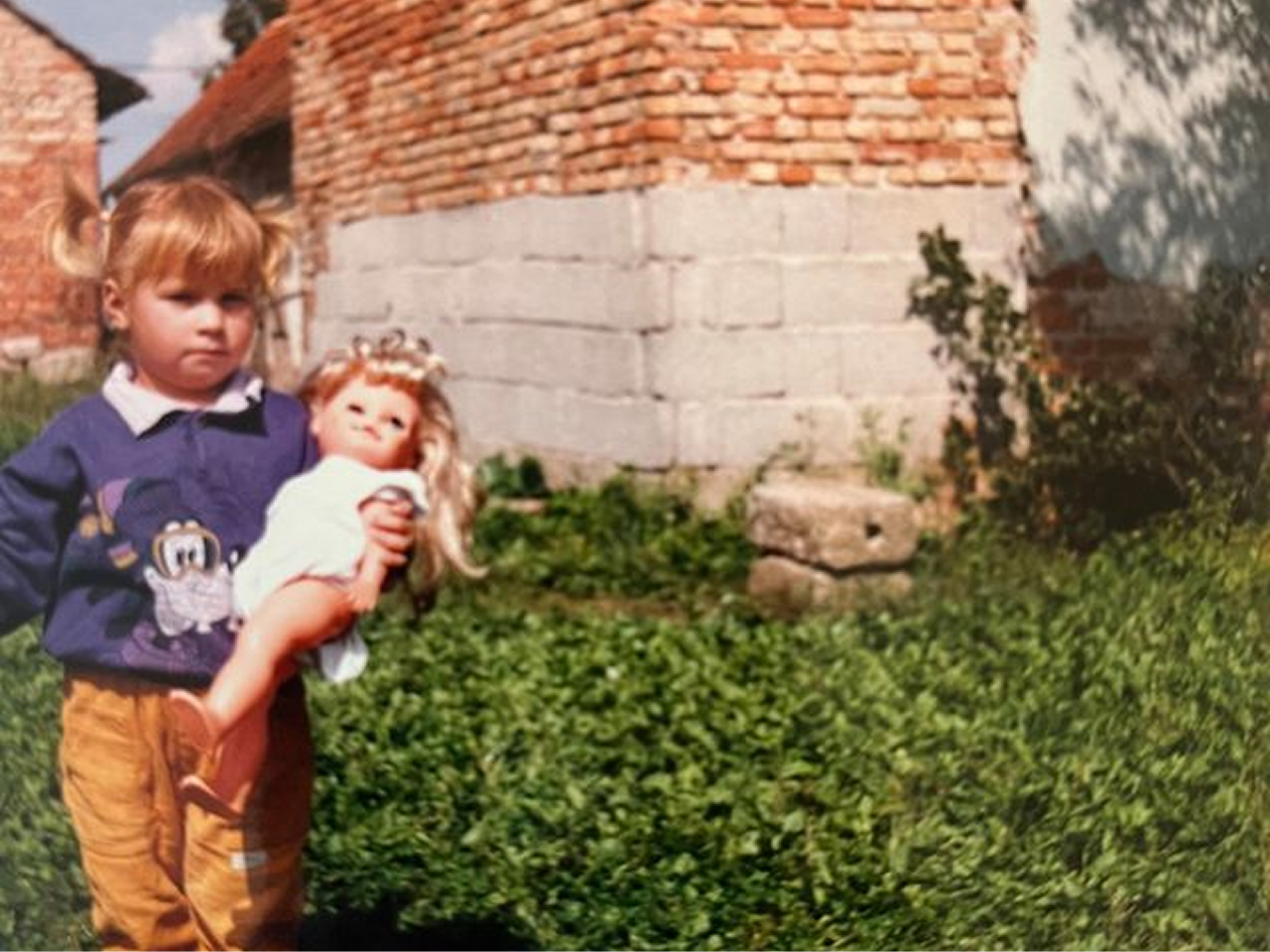 Mlada deklica z lutko v rokah