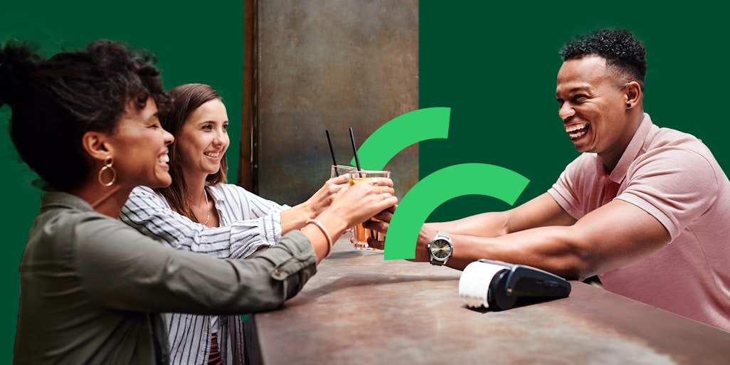 Bar man serving drinks using contactless payments