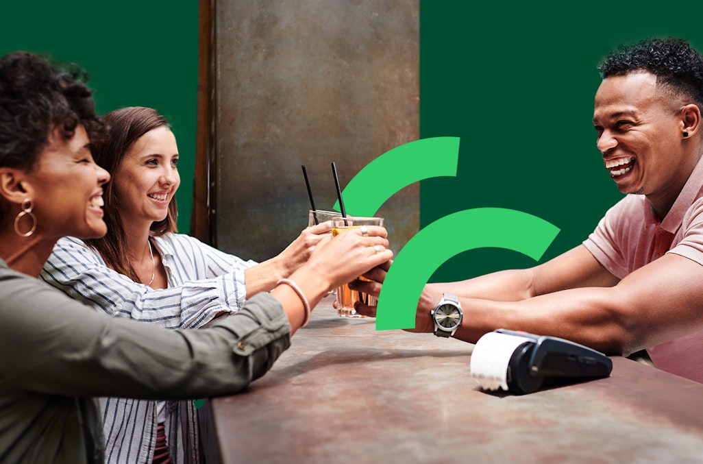 Bar man serving drinks using contactless payments