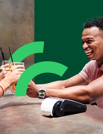 Bar man serving drinks using contactless payments