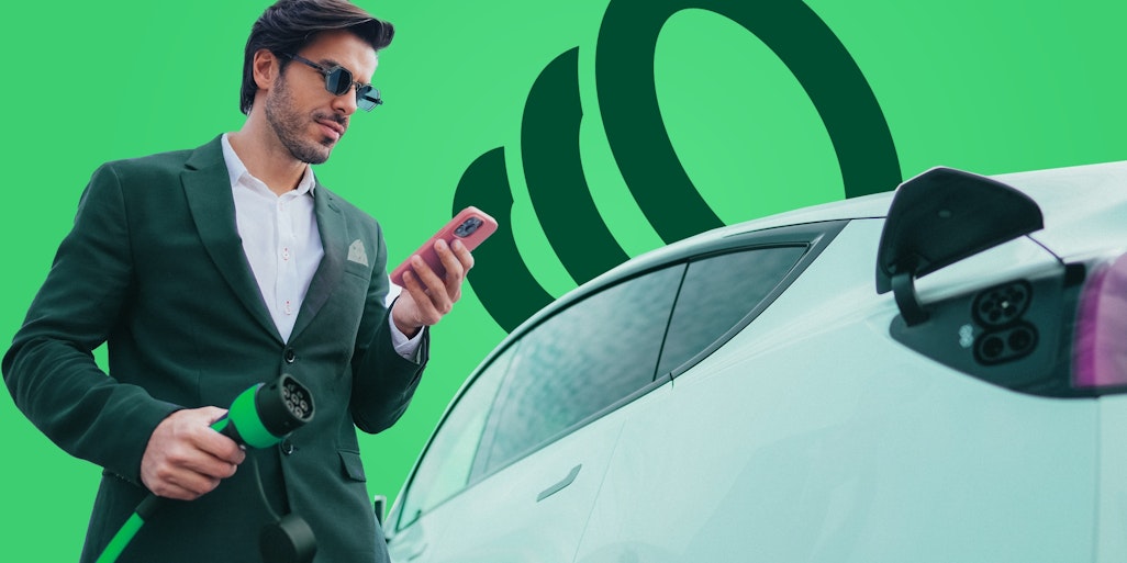 Man holding charging plug for electric car and charging app. EV charging & payments