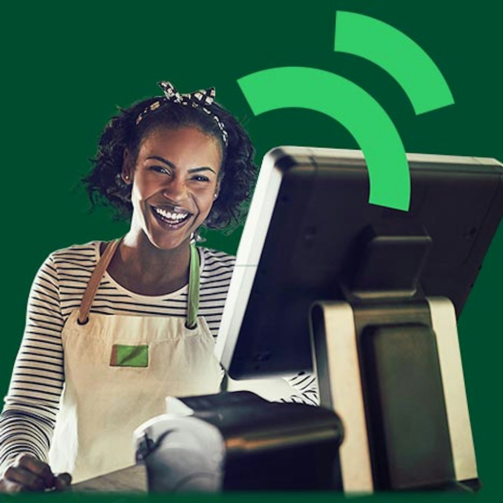 Cheerful woman using a cash register or Point of Sale