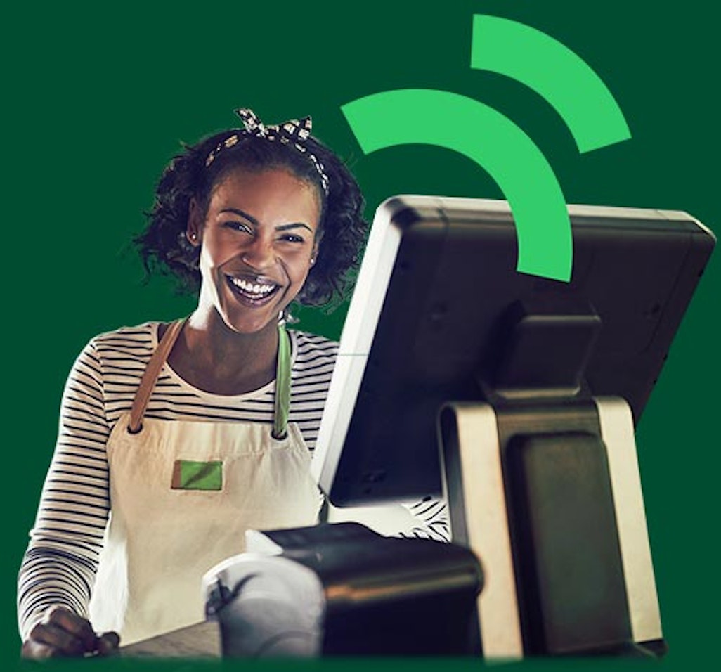 Cheerful woman using a cash register or Point of Sale
