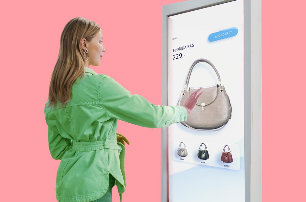 Woman using unattended payment solution with touch screen