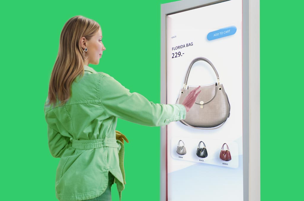 Woman using unattended payment solution with touch screen